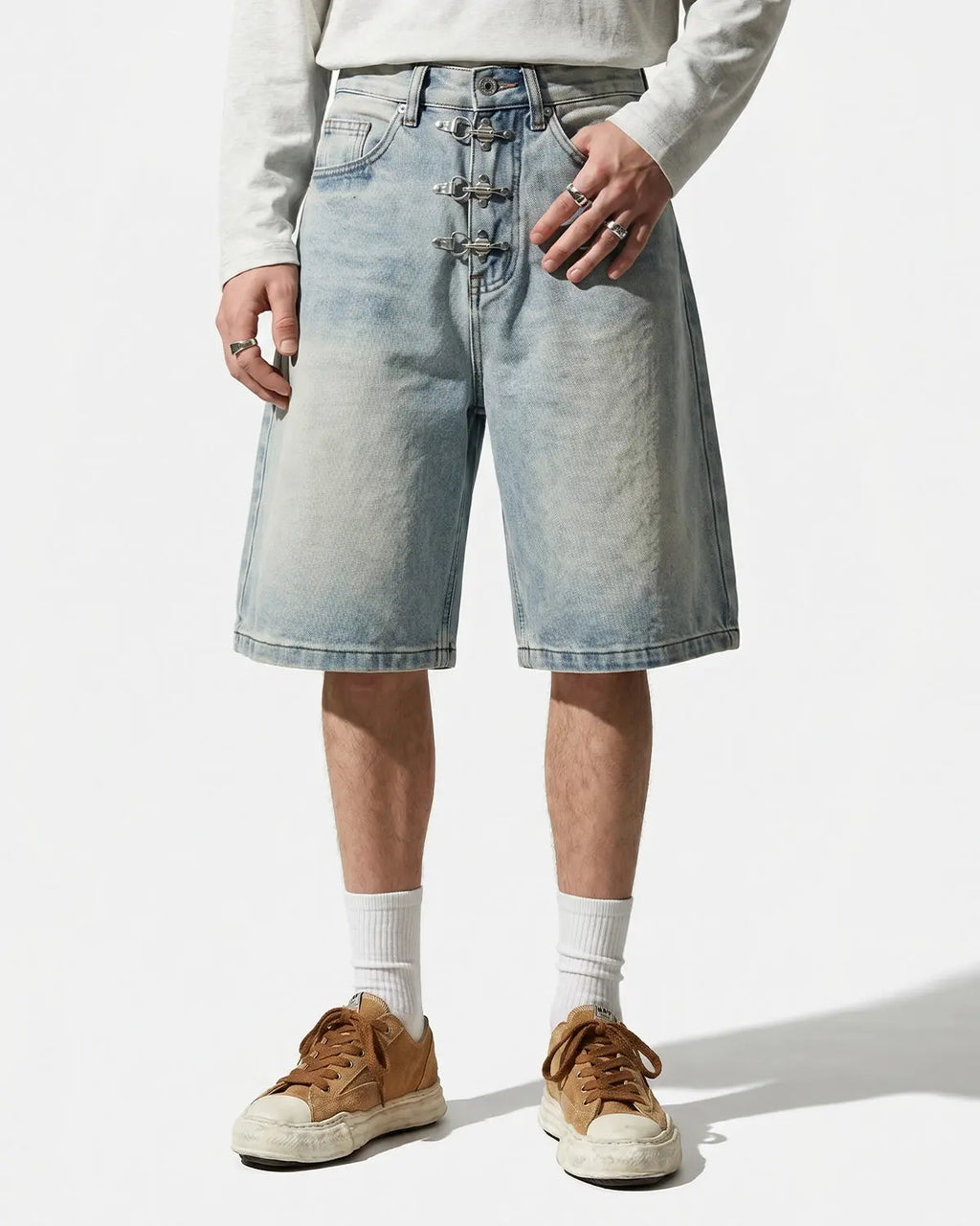 Metal clasp baggy jorts from Inflation Streetwear featuring distressed denim, loose fit, and metal buckle details.