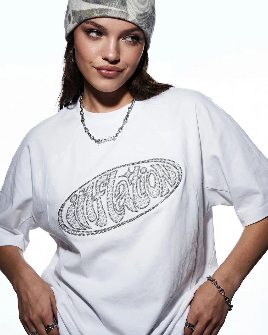 Hollow embroidered graphic T-shirt by INFLATION featuring bold design on white cotton fabric, casual streetwear style.