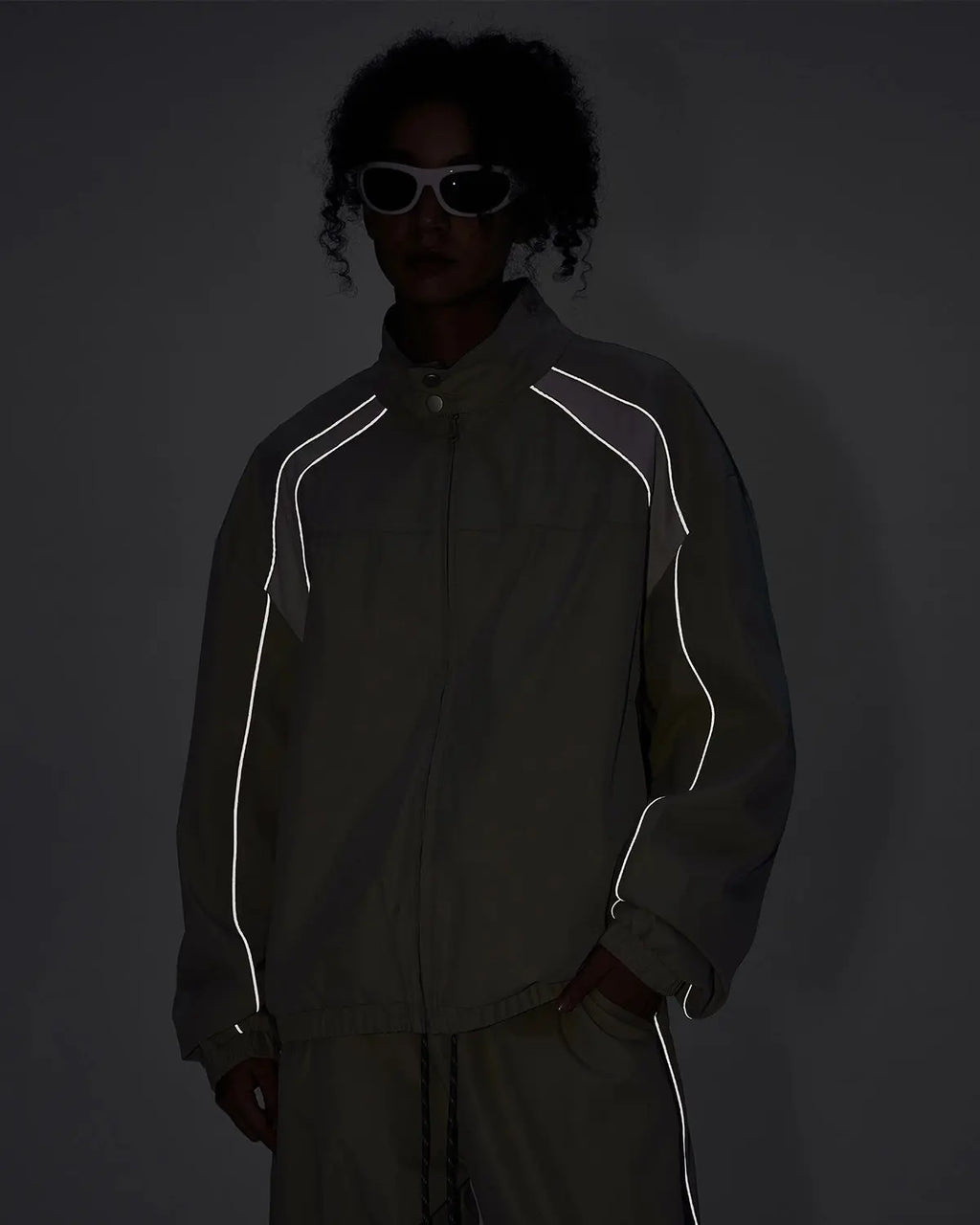 Reflective windbreaker track jacket by Flation Streetwear, featuring a sleek design with reflective accents and a sporty fit.