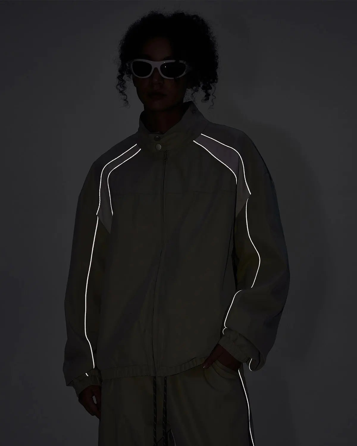 Reflective windbreaker track jacket by Flation Streetwear, featuring a sleek design with reflective accents and a sporty fit.