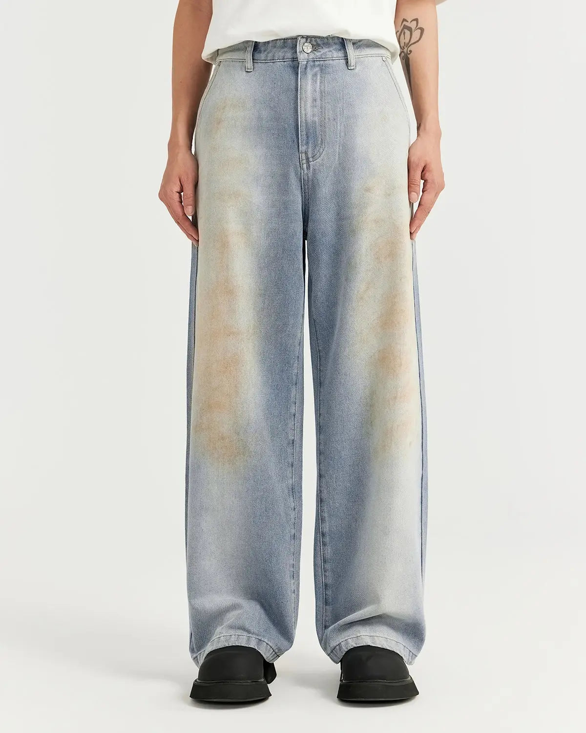 Mud washed baggy jeans by Flation Streetwear, featuring a relaxed fit and distressed denim design.