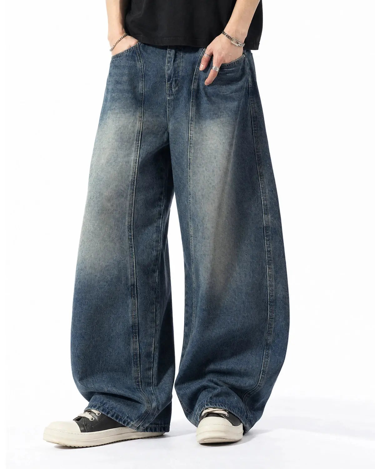 Deconstructed Barrel Jeans by INFLATION, stylish streetwear pants with distressed details and unique layered design.