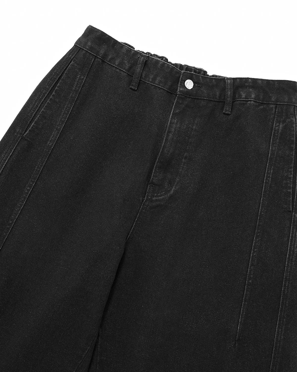 Acid washed black barrel jeans by INFLATION Streetwear, showing the relaxed fit and distressed denim texture.