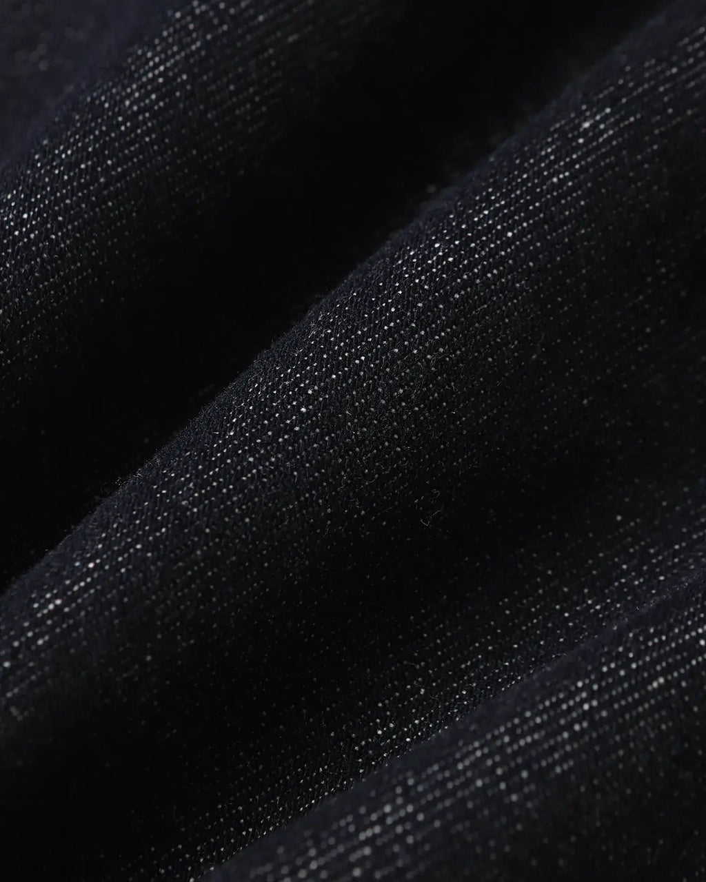 Deconstructed scimitar denim longline jorts by INFLATION, showing distressed details and long, loose fit on a casual pants style.