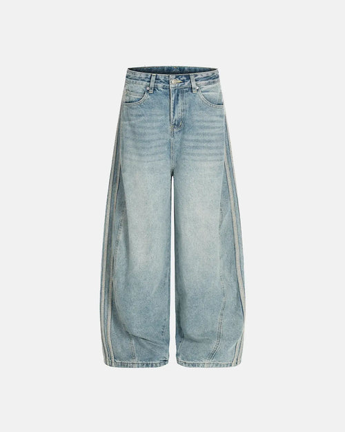 Acid wash striped side baggy jeans by INFLATION, featuring relaxed fit, distressed detailing, and contrasting stripe accents.