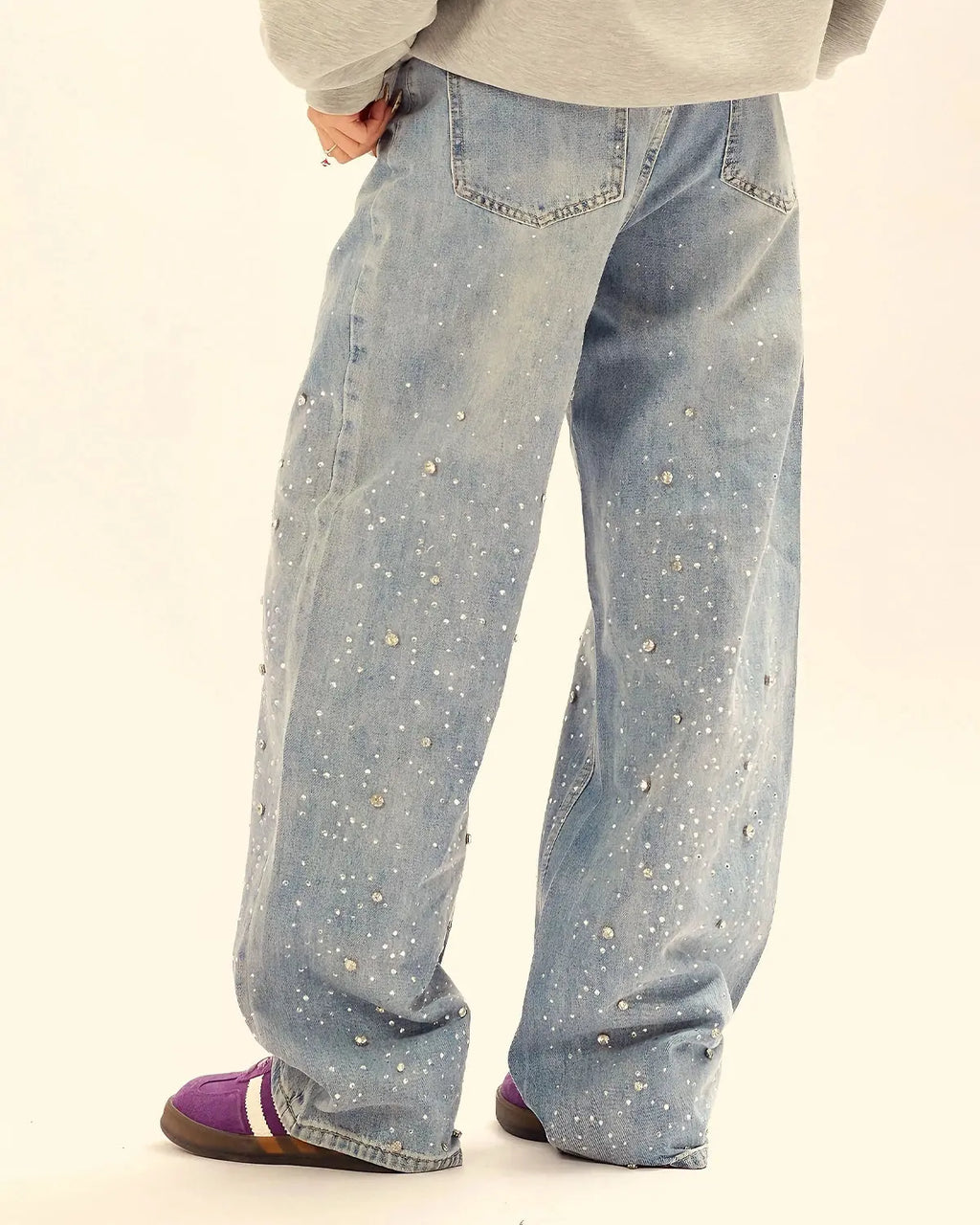 Flation studded rhinestone baggy jeans with distressed details and wide-leg fit, showcasing a trendy streetwear style.