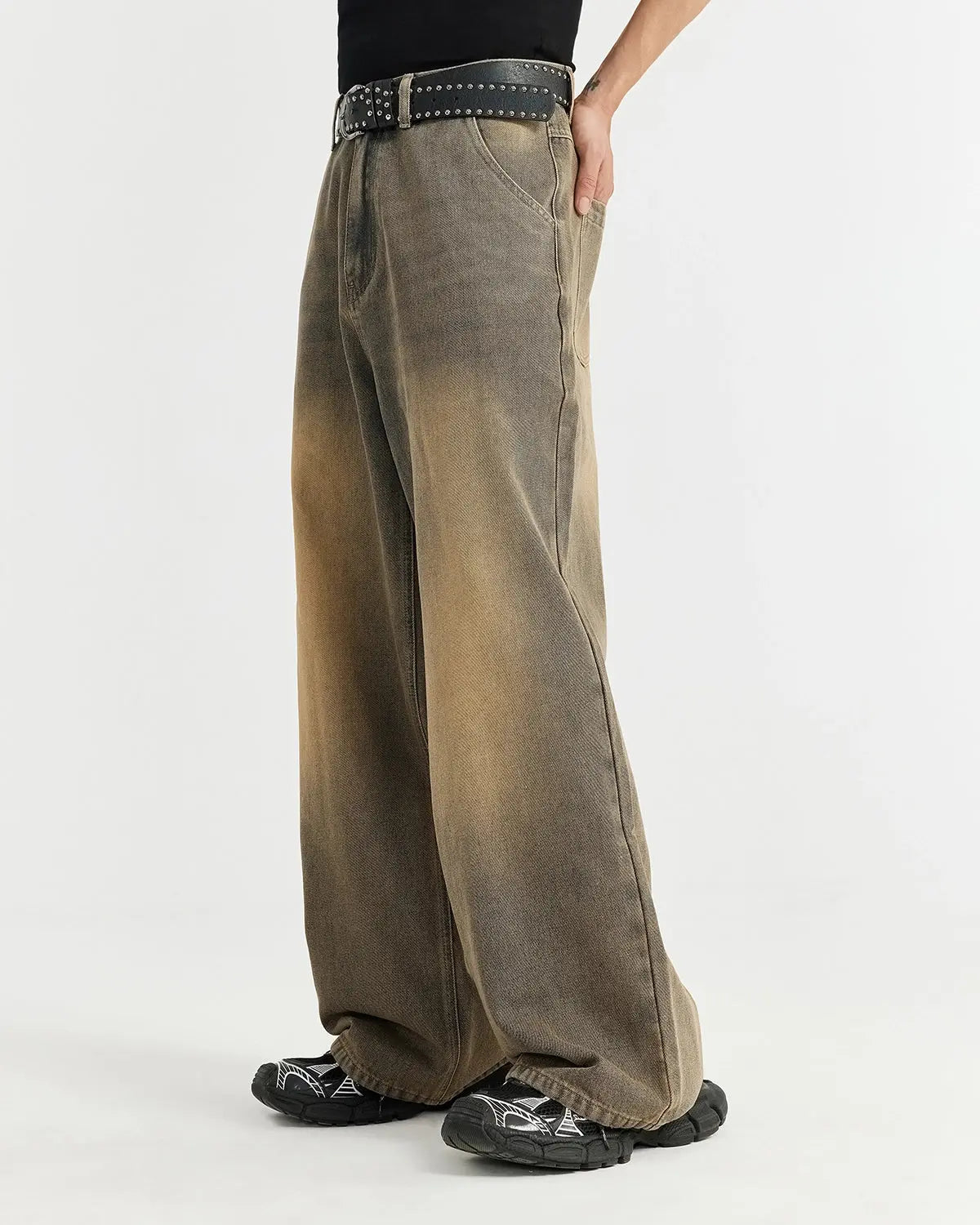 Brown acid wash baggy jeans by Flation Streetwear, showing relaxed fit with distressed acid wash denim and casual style.