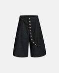 Asymmetric button raw denim jorts by INFLATION, featuring distressed raw denim fabric and unique asymmetric design.