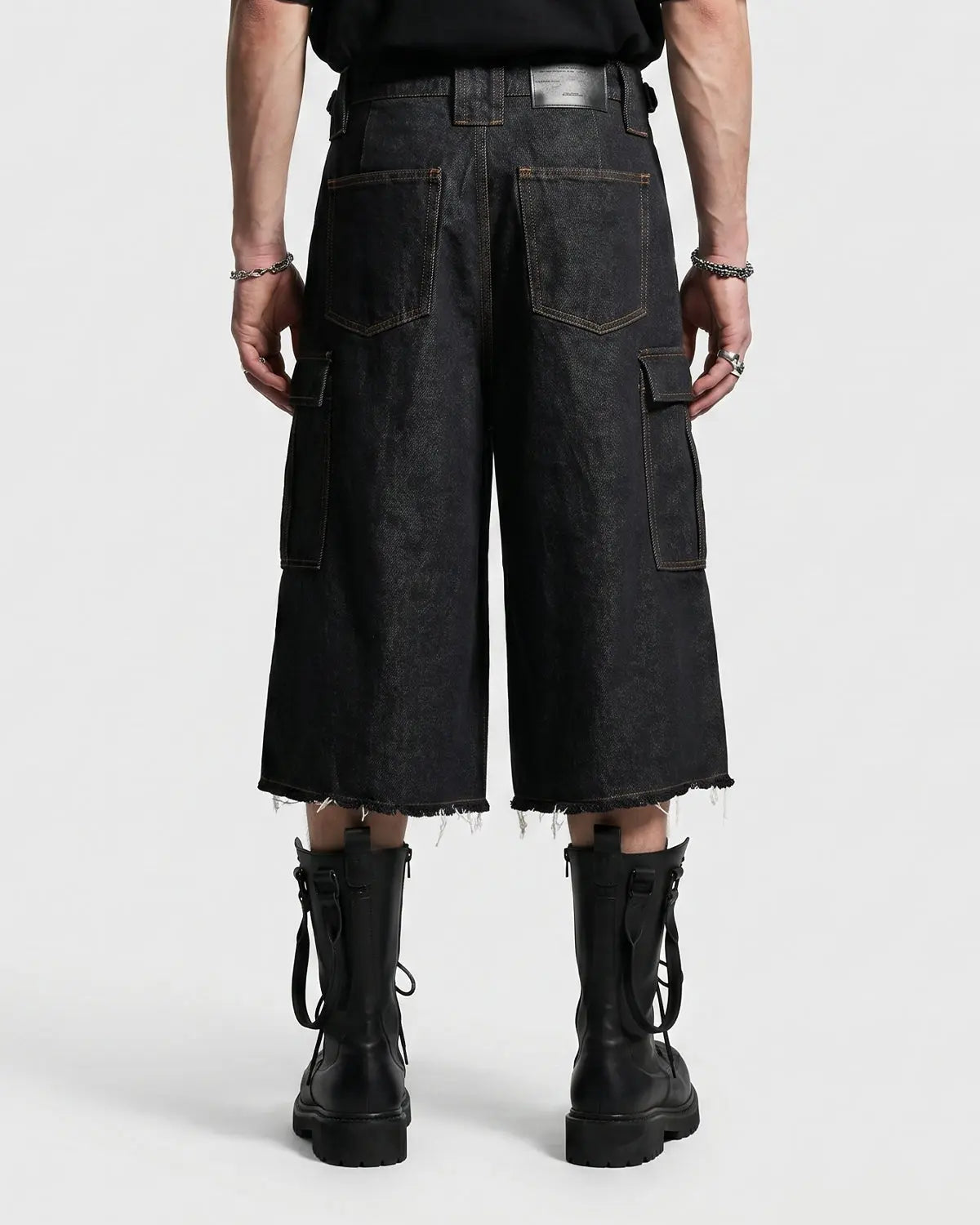Layered utility baggy jorts pants by INFLATION featuring a loose fit, multiple pockets, and distressed denim style.