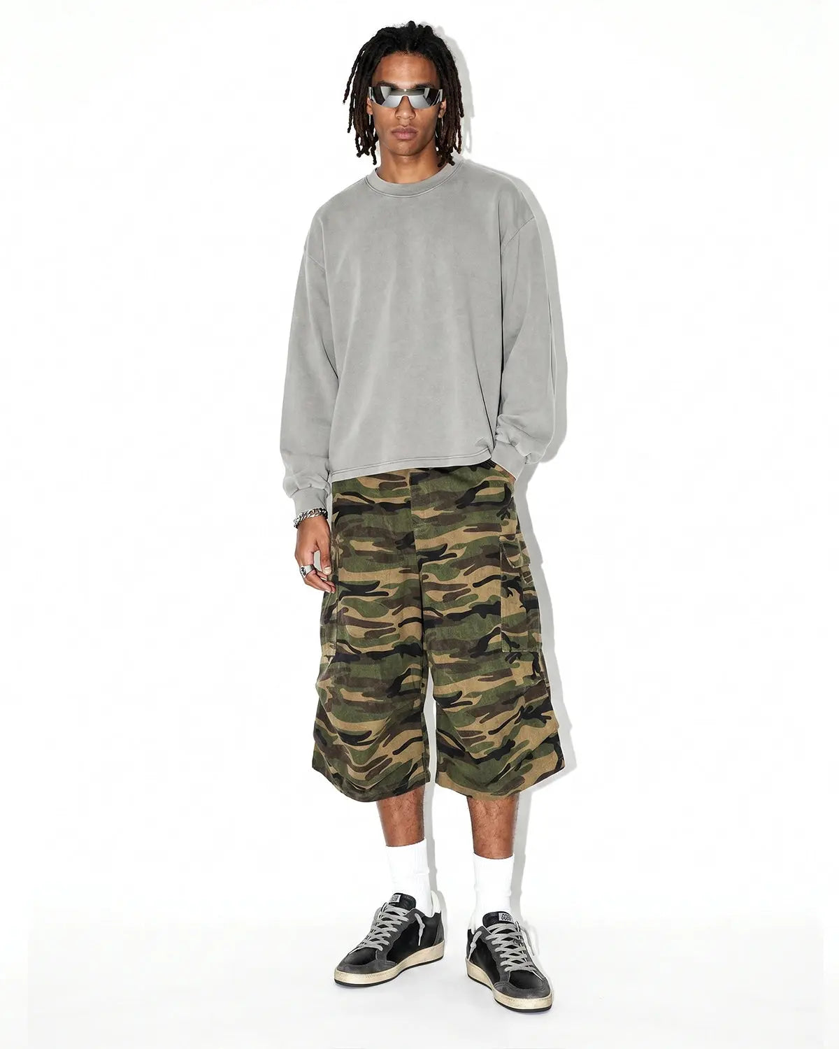 Inflation Camo Cargo Baggy Shorts with multiple pockets, relaxed fit, and streetwear style in green camouflage fabric.