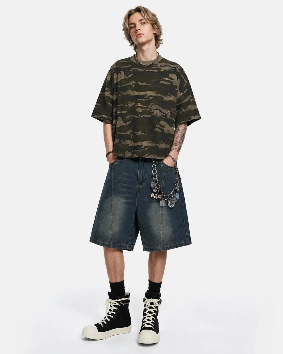 Deconstructed washed denim jorts by INFLATION, casual jeans shorts with distressed details and frayed hems, styled as streetwear pants.