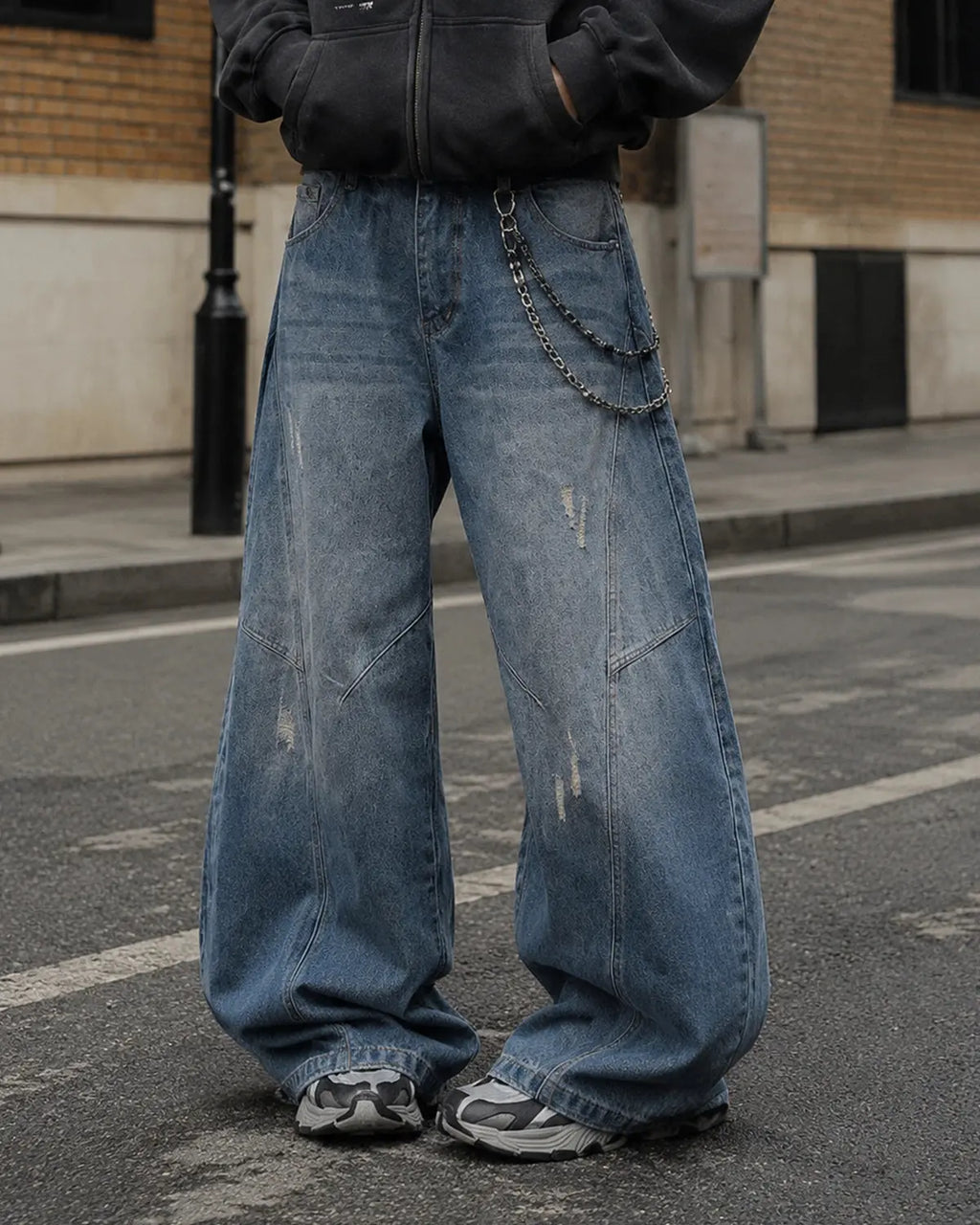 Distressed ripped baggy jeans by Flation Streetwear, showing faded denim, large rips, and relaxed fit pants.