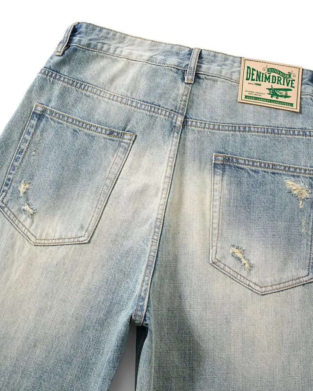 Distressed ripped straight-leg jeans by Inflation Streetwear, showing the frayed knees and casual fit on light denim fabric.