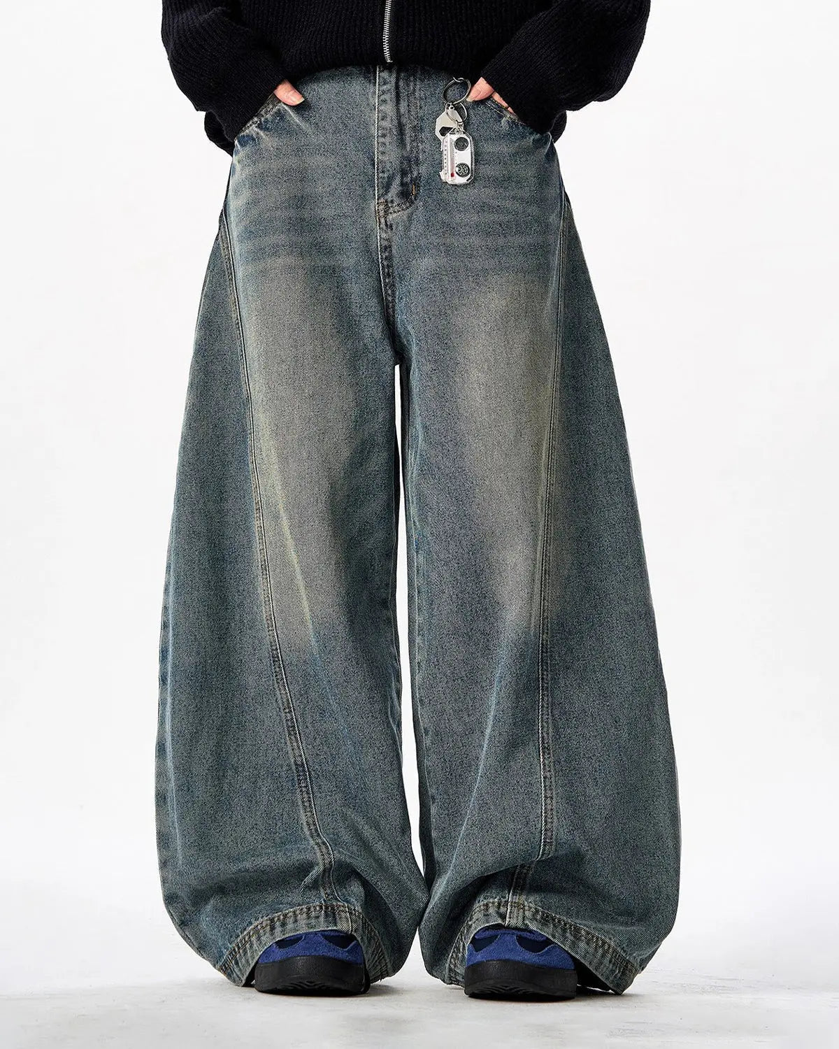 Vintage Washed Barrel Jeans by INFLATION, showing rugged denim with faded, distressed details and a relaxed fit.