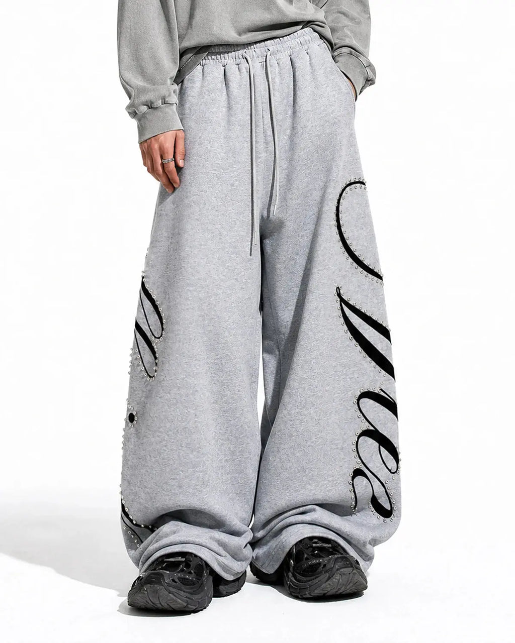 Inflation Rhinestone Script Baggy Sweatpants featuring sparkling rhinestone lettering and a relaxed streetwear fit.
