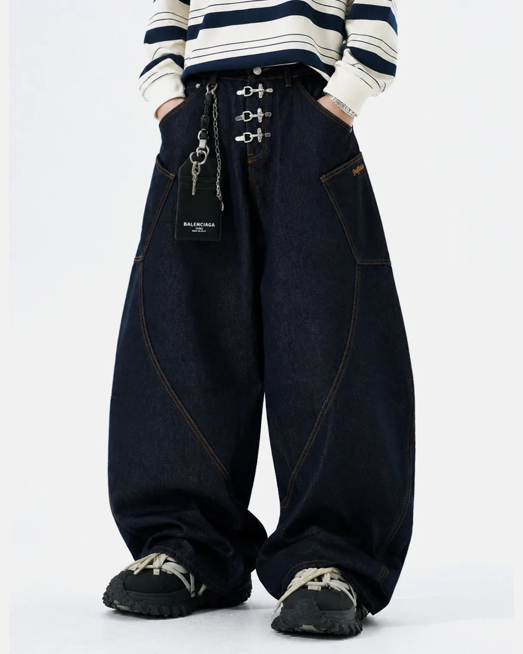 Raw barrel jeans by INFLATION featuring metal clasp hardware and classic denim construction.