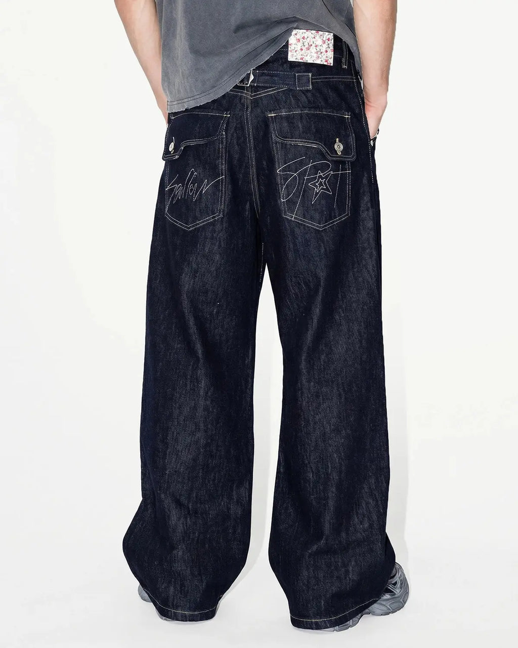 Inflation selvedge buckle baggy jeans featuring distressed denim, relaxed fit, and stylish hardware details.