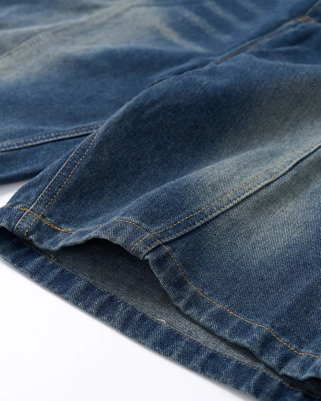 Deconstructed washed denim jorts by INFLATION, casual denim pants with a distressed, trendy look and frayed hems.