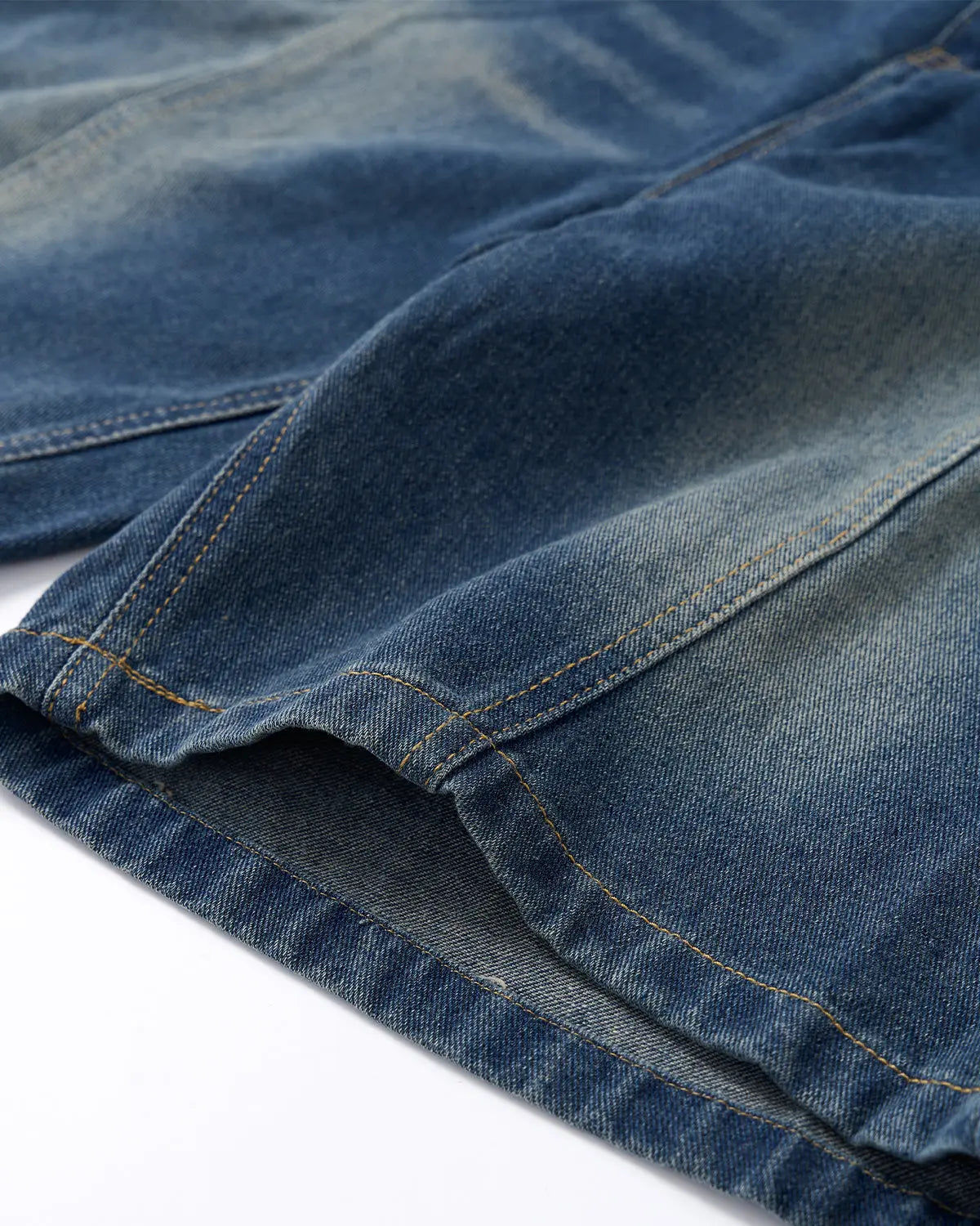 Deconstructed washed denim jorts by INFLATION, casual denim pants with a distressed, trendy look and frayed hems.
