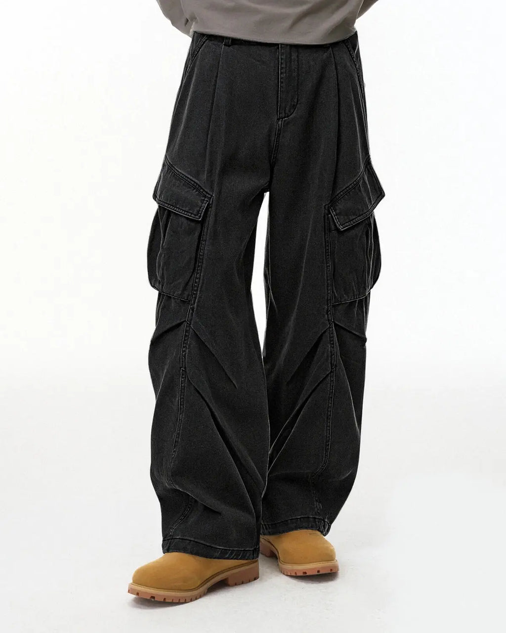 Inflation brand baggy cargo pants with multiple large pockets, relaxed fit, and streetwear style, shown on a model.
