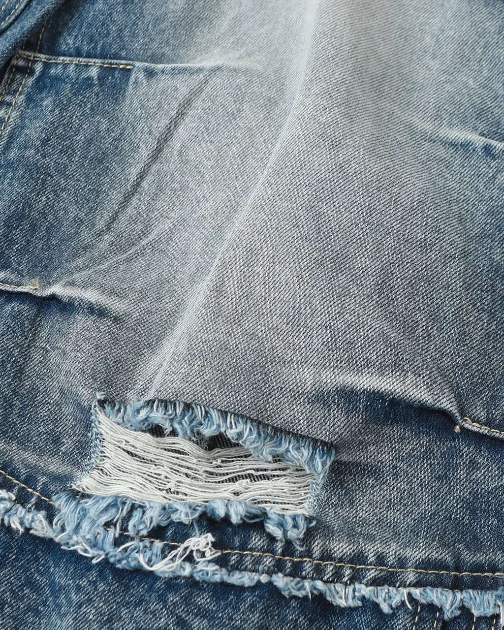 Inflation Streetwear Cinch Back Deconstructed Distressed Barrel Jeans, stylish men's pants with a relaxed fit and raw hem details.