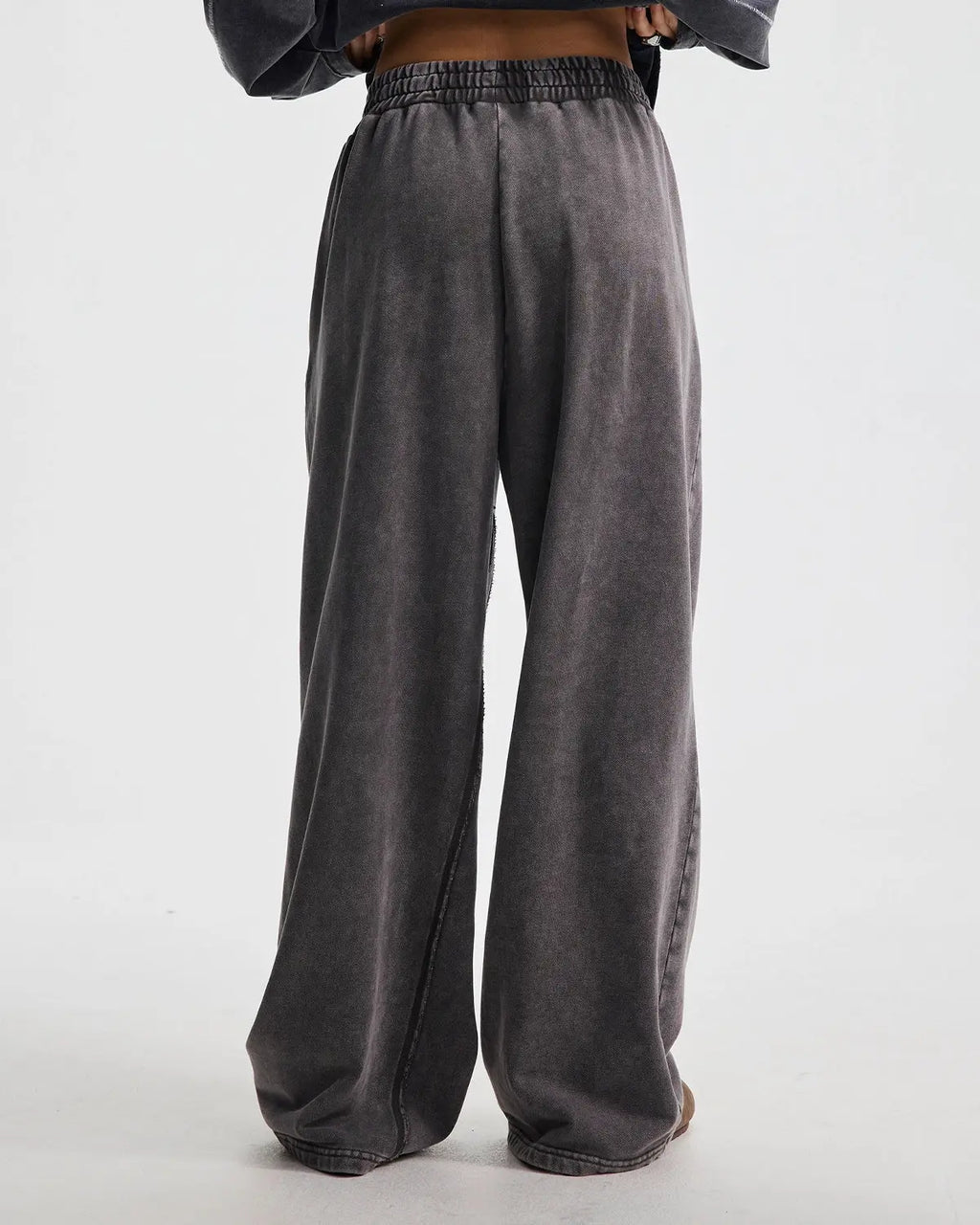 Flation streetwear straight leg acid wash sweatpants showing a relaxed fit with distressed denim texture and casual style.