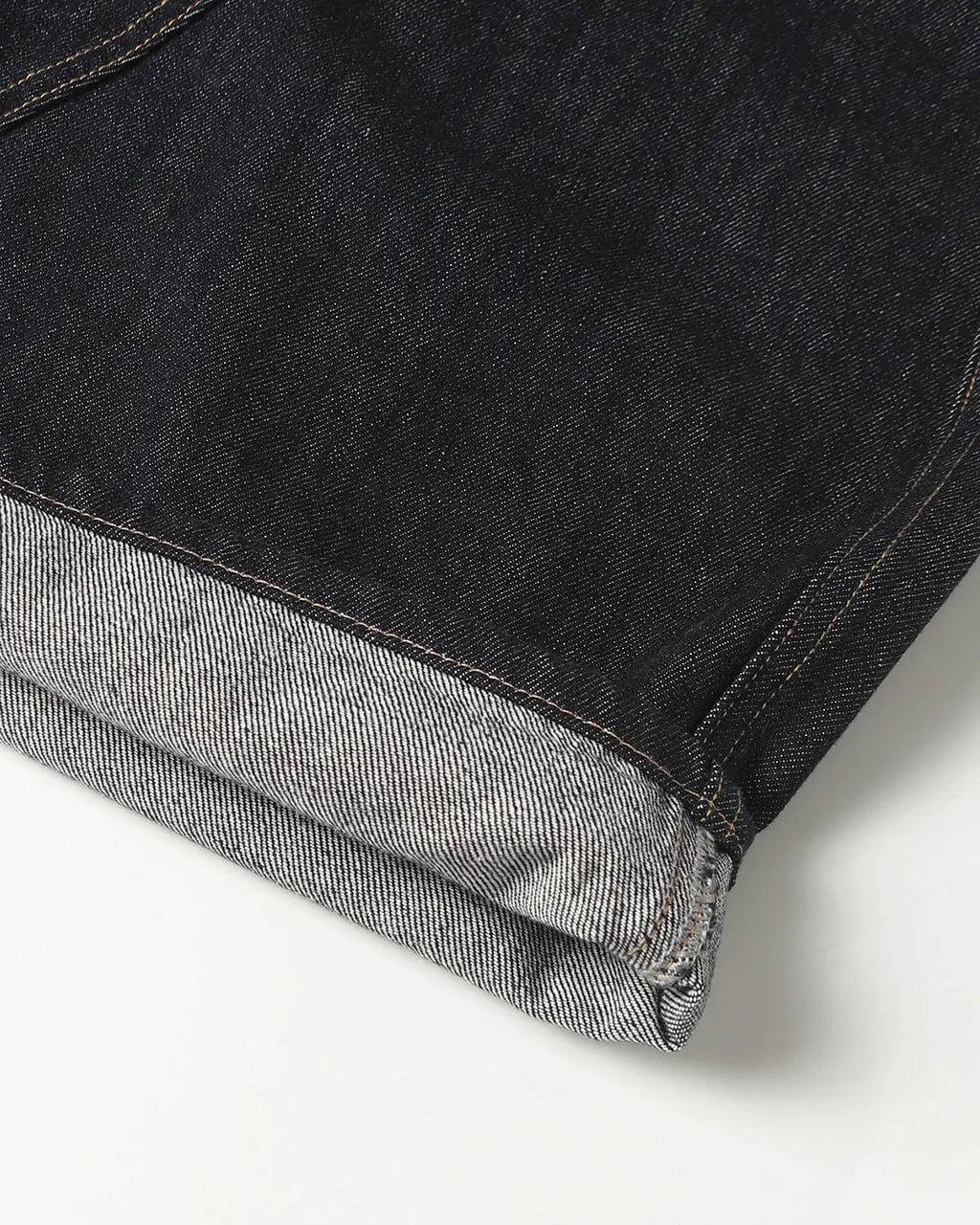 Deconstructed Scimitar Denim Longline Jorts by INFLATION, stylish distressed denim pants with a long, relaxed fit and unique cut details.