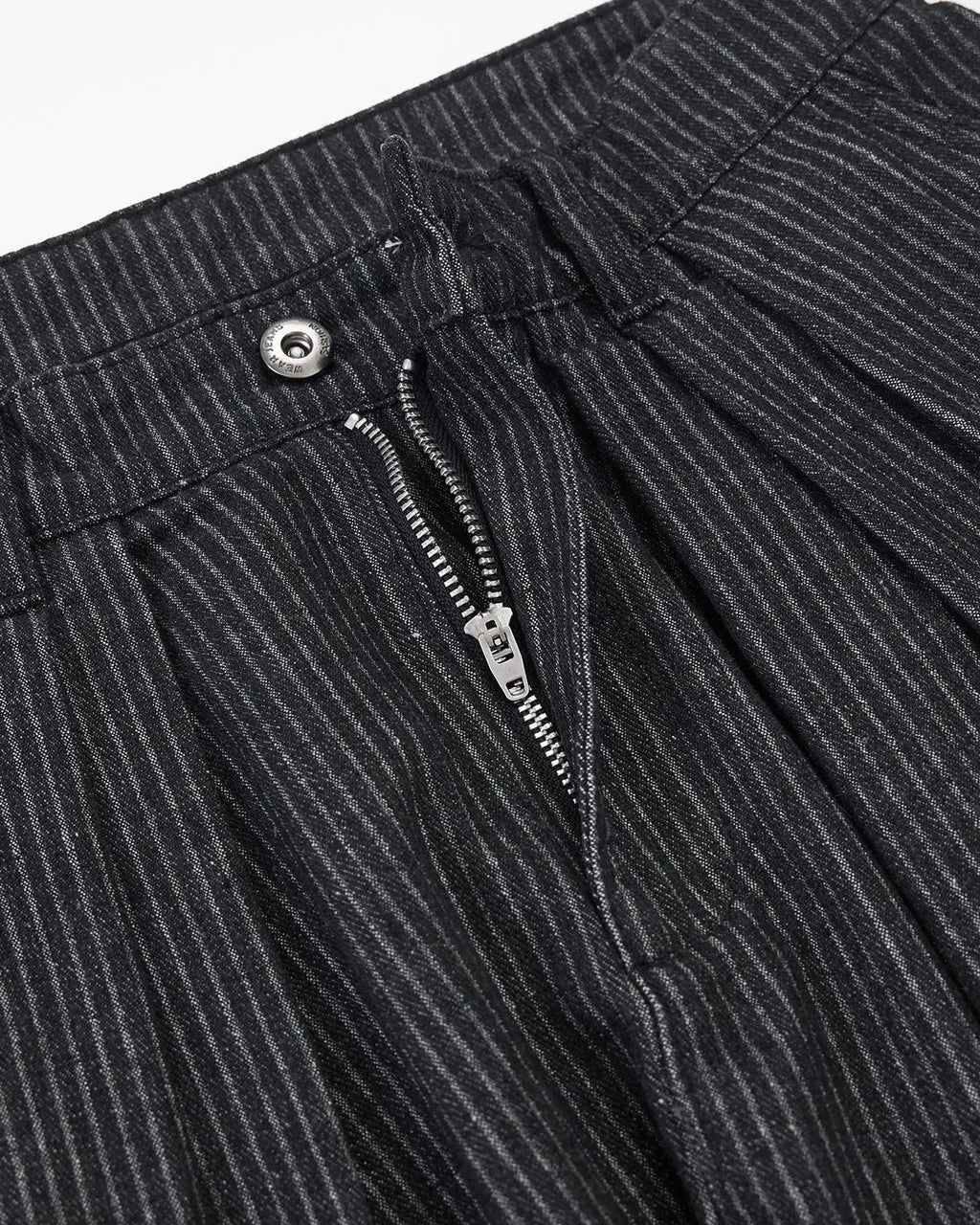 Vintage pinstripe pleated barrel jeans by INFLATION, showing the high-waisted, relaxed fit pants with pleats and pinstripe pattern.