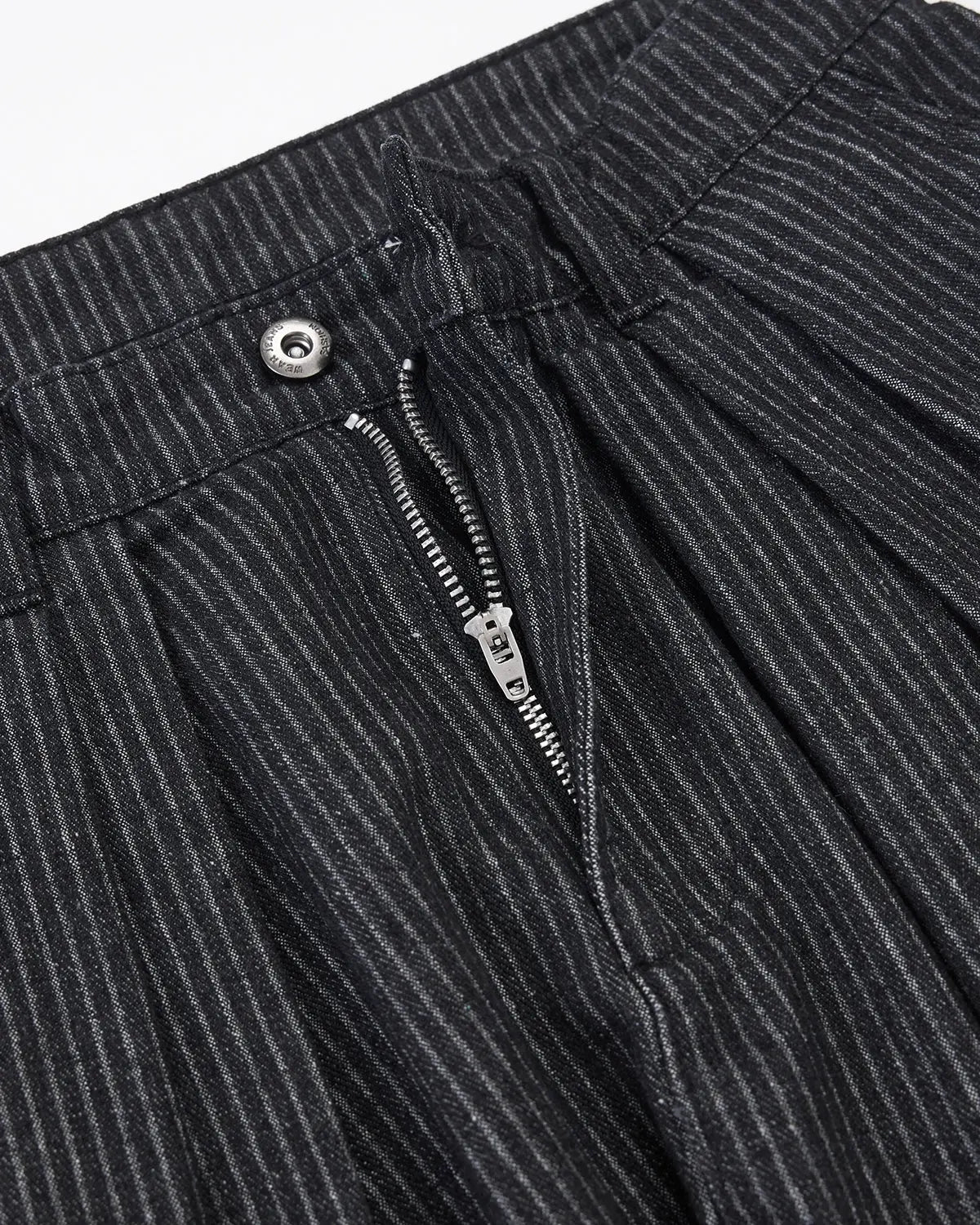 Vintage pinstripe pleated barrel jeans by INFLATION, showing the high-waisted, relaxed fit pants with pleats and pinstripe pattern.