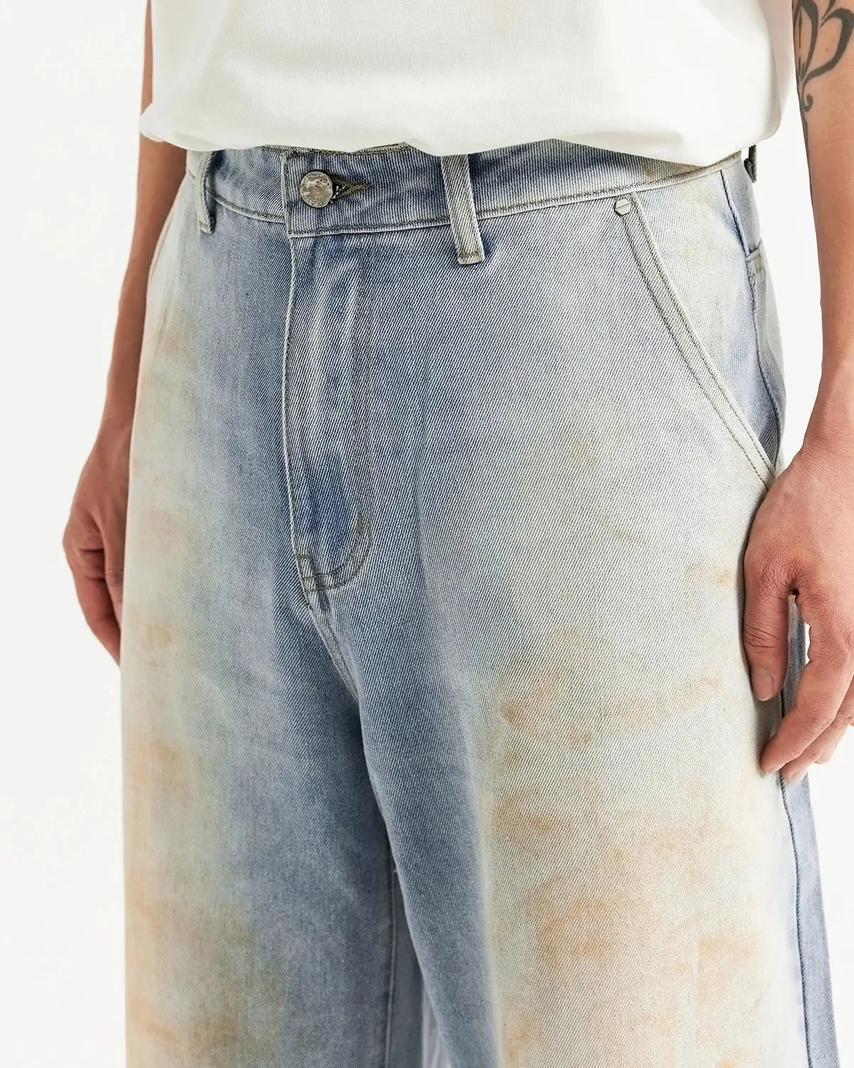 Flation Mud Washed Baggy Jeans with relaxed fit and faded denim texture, featuring distressed details and a casual streetwear style.