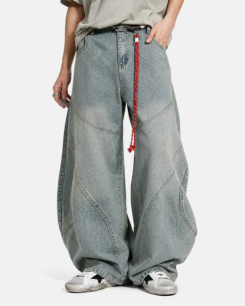 Acid wash baggy jeans from Flation Streetwear with prominent stitching and relaxed fit, displayed on a plain background.
