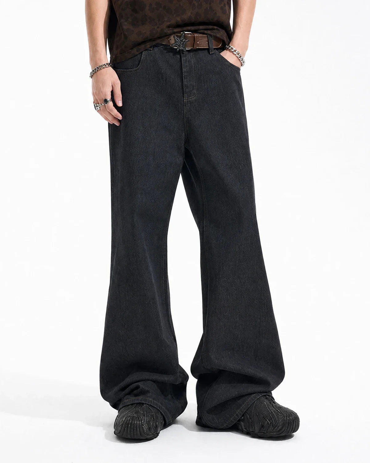Flation Super Raw Flared Baggy Jeans hanging on a rack, showcasing their wide-leg, distressed denim style and streetwear design