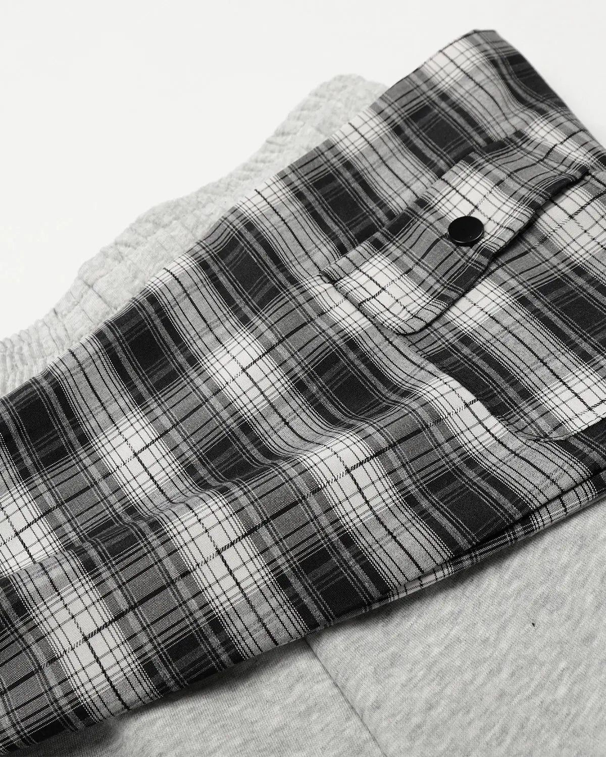 Plaid layered baggy sweatpants by INFLATION featuring a relaxed fit and streetwear style, with a layered, oversized design.