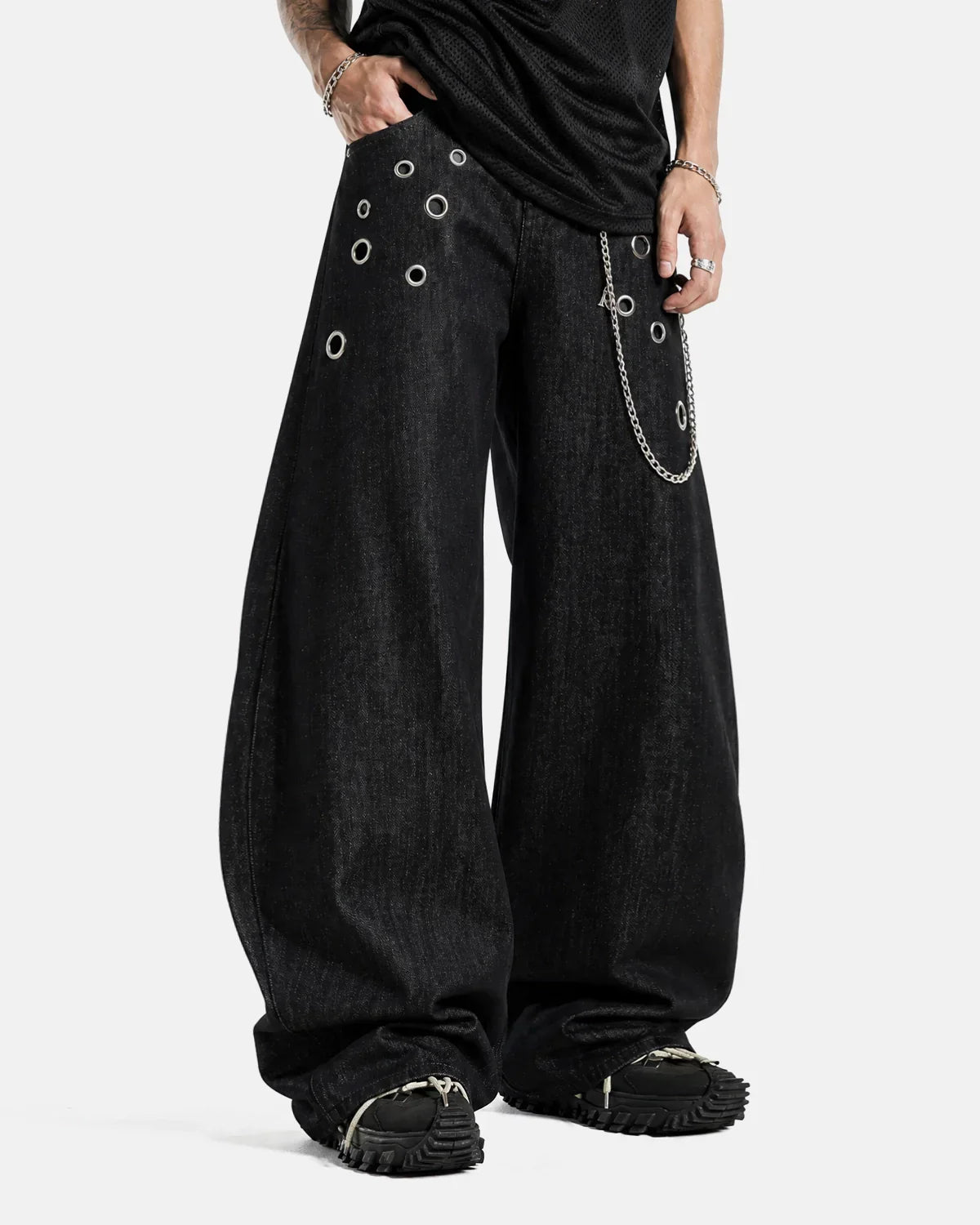 Metal eyelet chain barrel jeans by INFLATION featuring distressed denim and metal chain details on the legs.
