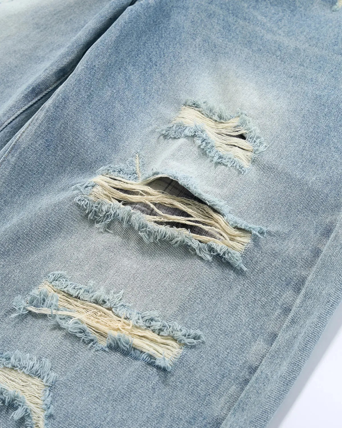 Vintage wash distressed baggy jeans by INFLATION Streetwear, featuring faded denim and relaxed fit with distressed details.
