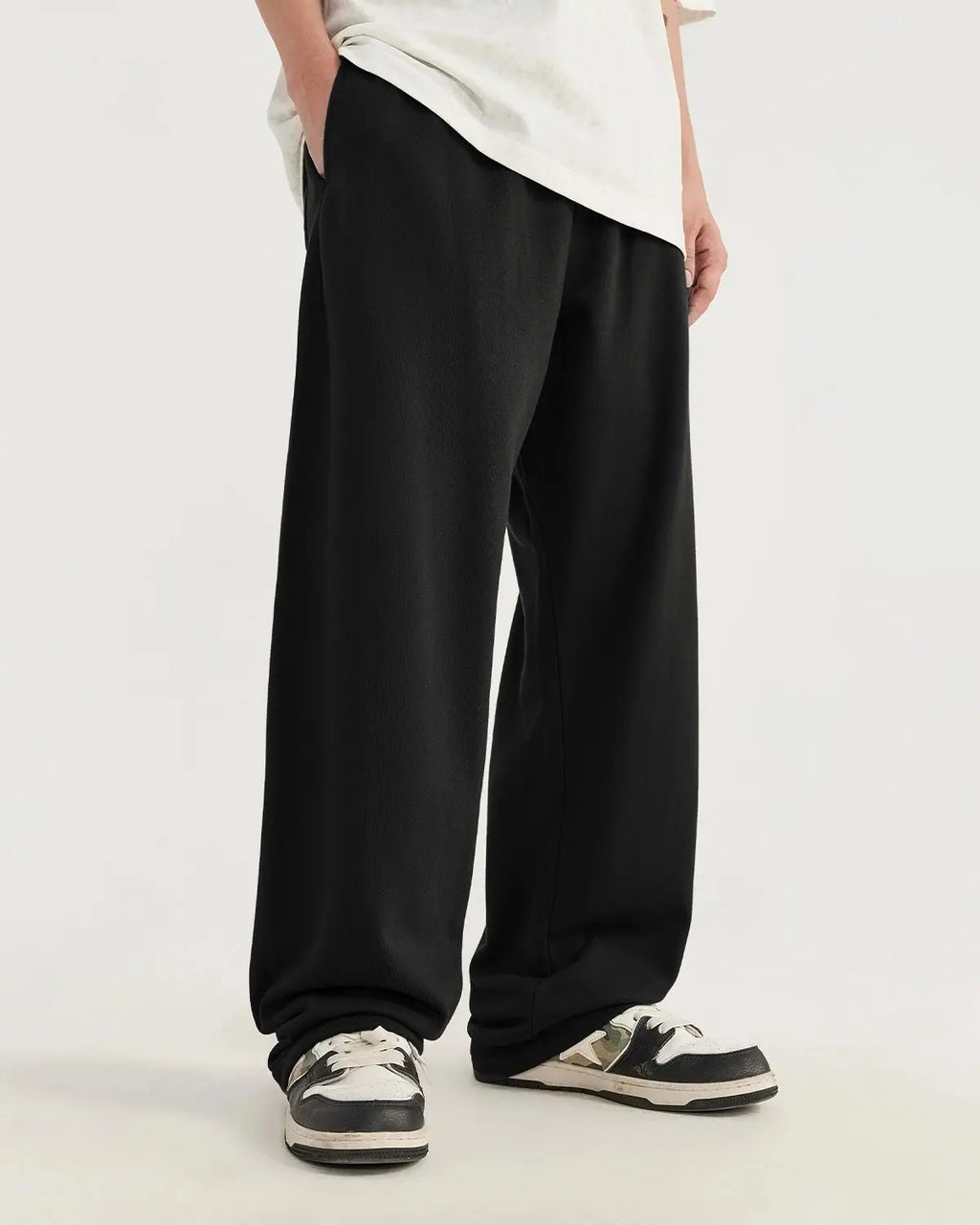 Inflation Heavyweight Straight-Leg Sweatpant in black, showing a relaxed fit and elastic waistband on a model.