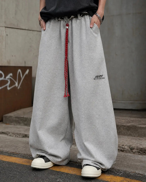 Flation brand baggy wide-leg sweatpants with elastic waistband and relaxed fit, casual streetwear style, black color.