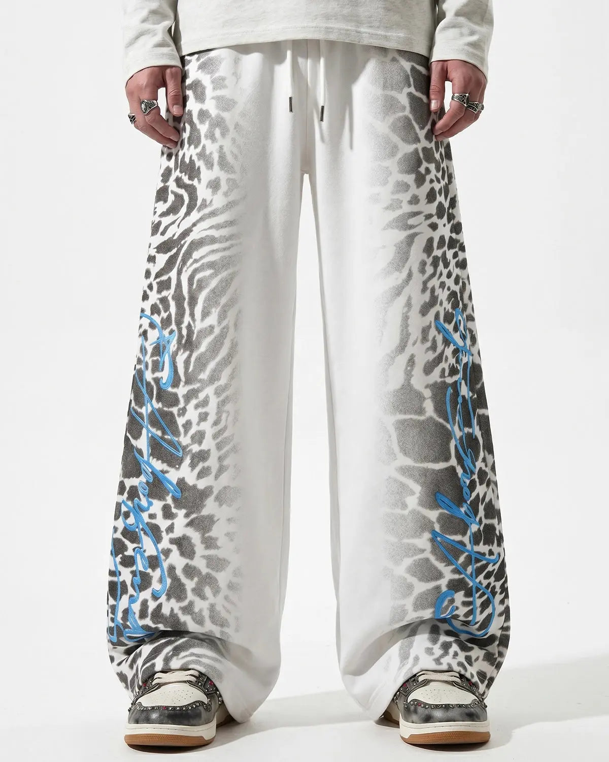 Leopard graphic barrel sweatpants by INFLATION featuring bold animal print and relaxed streetwear style.