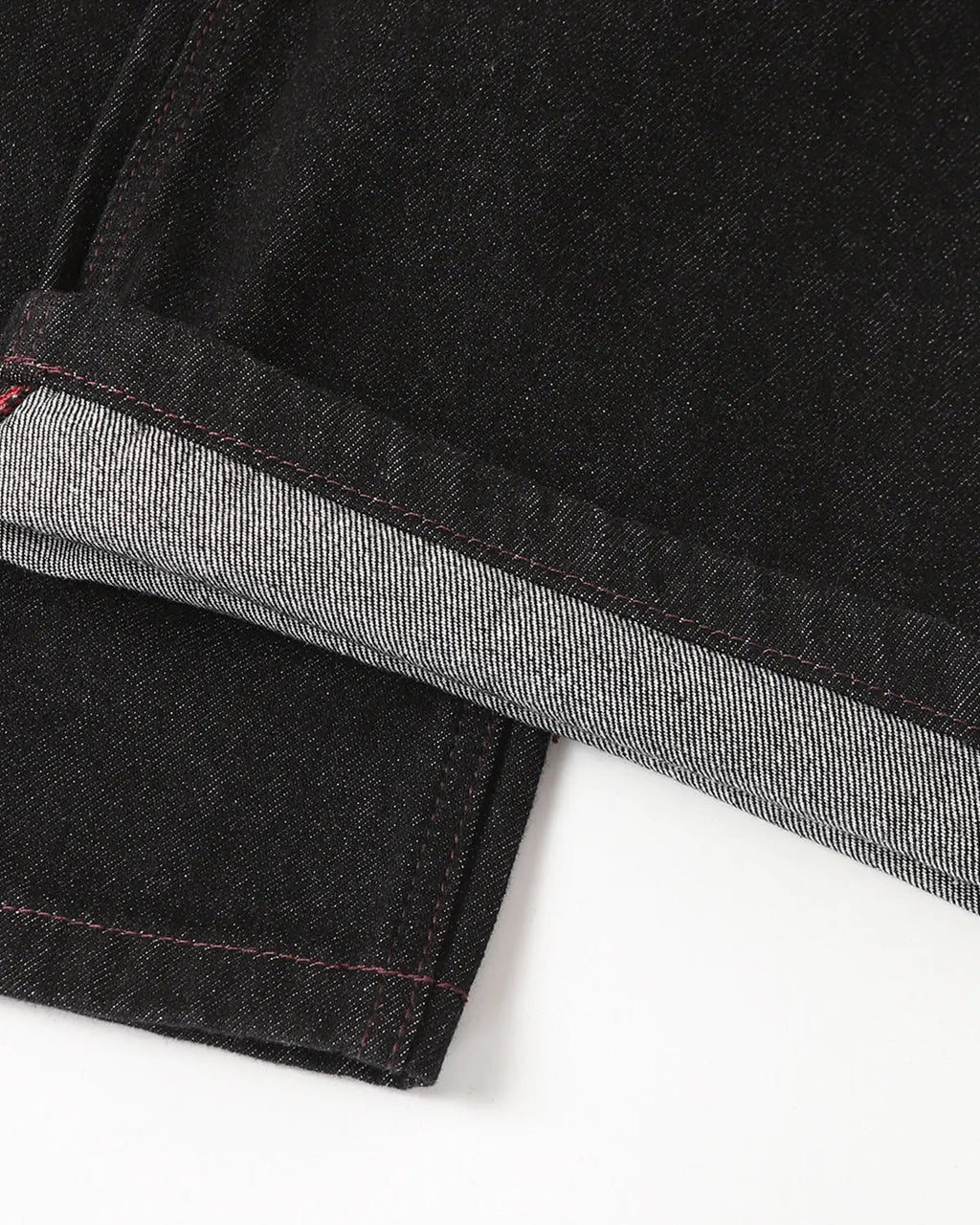 Raw bootcut jeans with deconstructed stitching details from Inflation Streetwear, showcasing distressed denim and unique design elements.