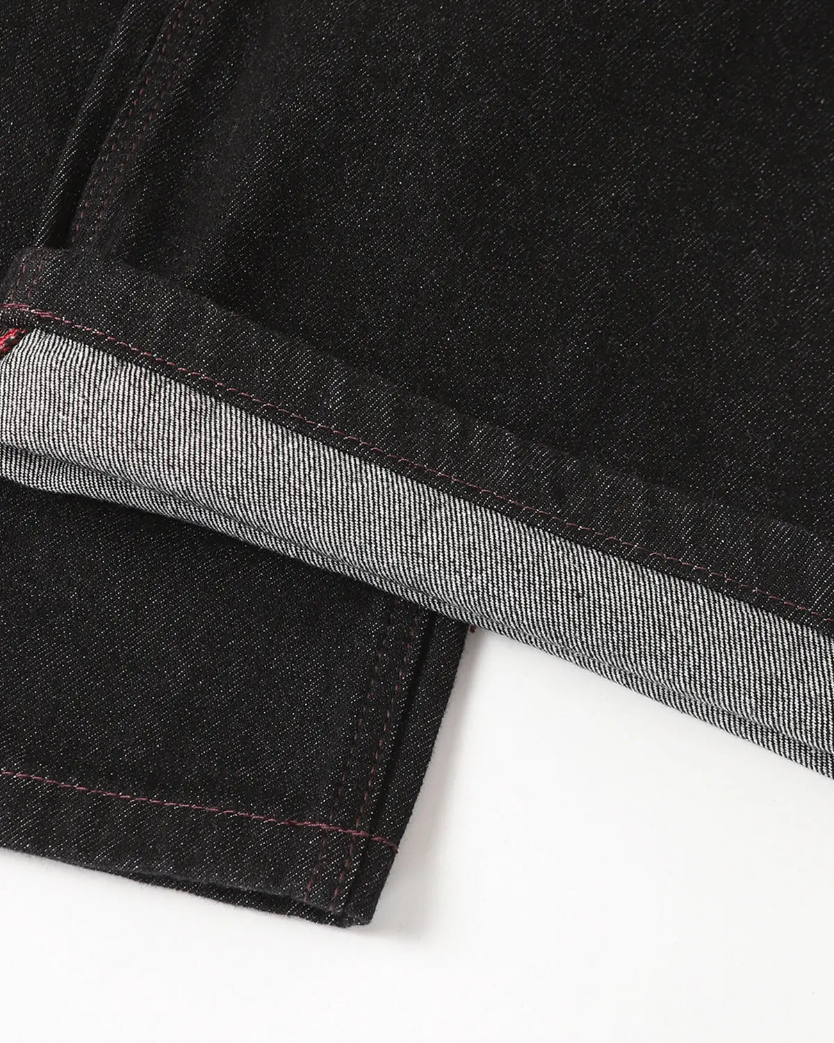 Raw bootcut jeans with deconstructed stitching details from Inflation Streetwear, showcasing distressed denim and unique design elements.