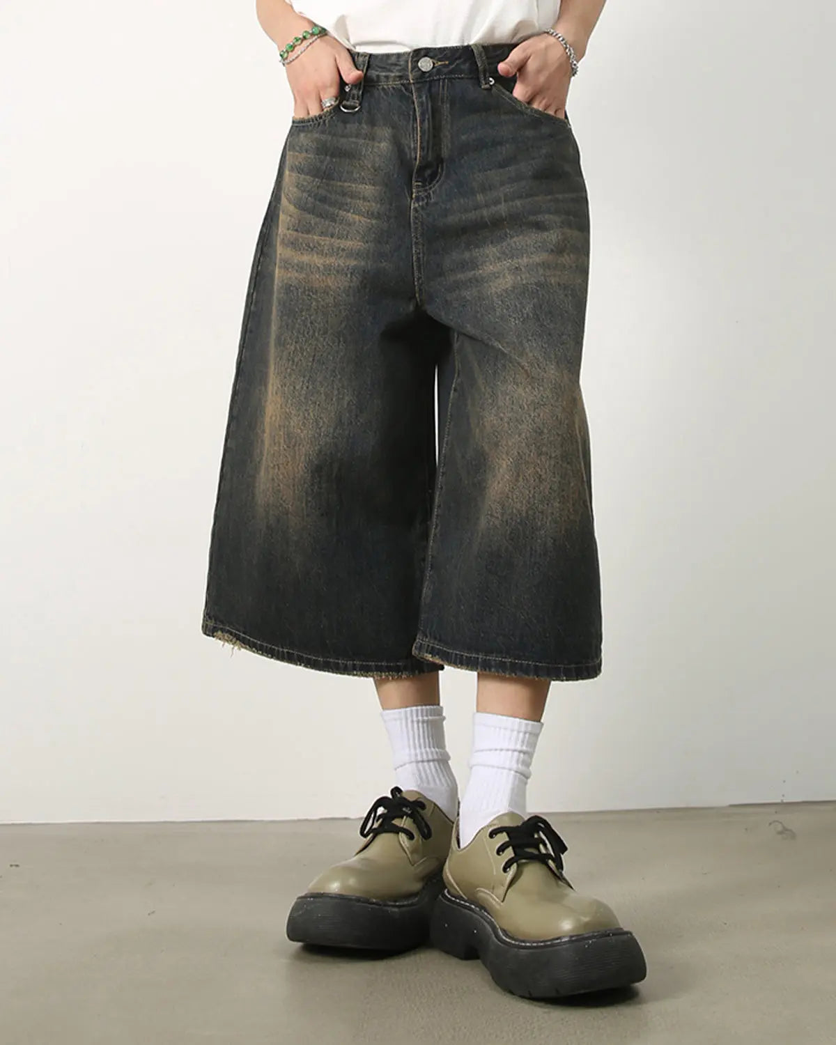 Washed baggy denim jorts by INFLATION featuring a relaxed fit, distressed details, and casual streetwear style.