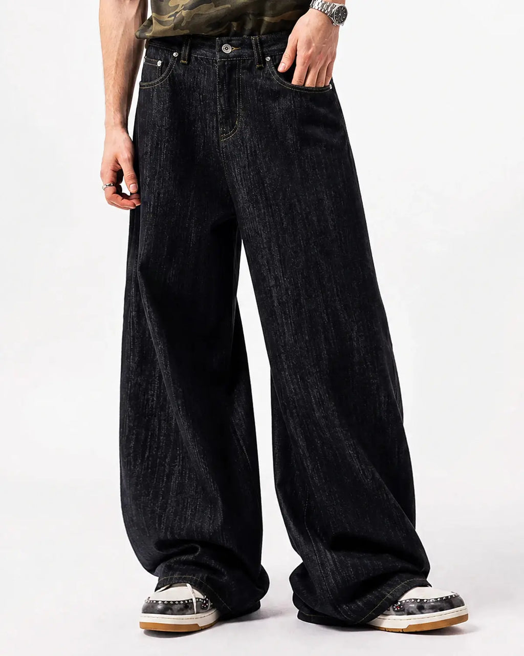 Embroidered Raw Baggy Jeans by INFLATION featuring loose fit and intricate embroidery details on denim fabric.