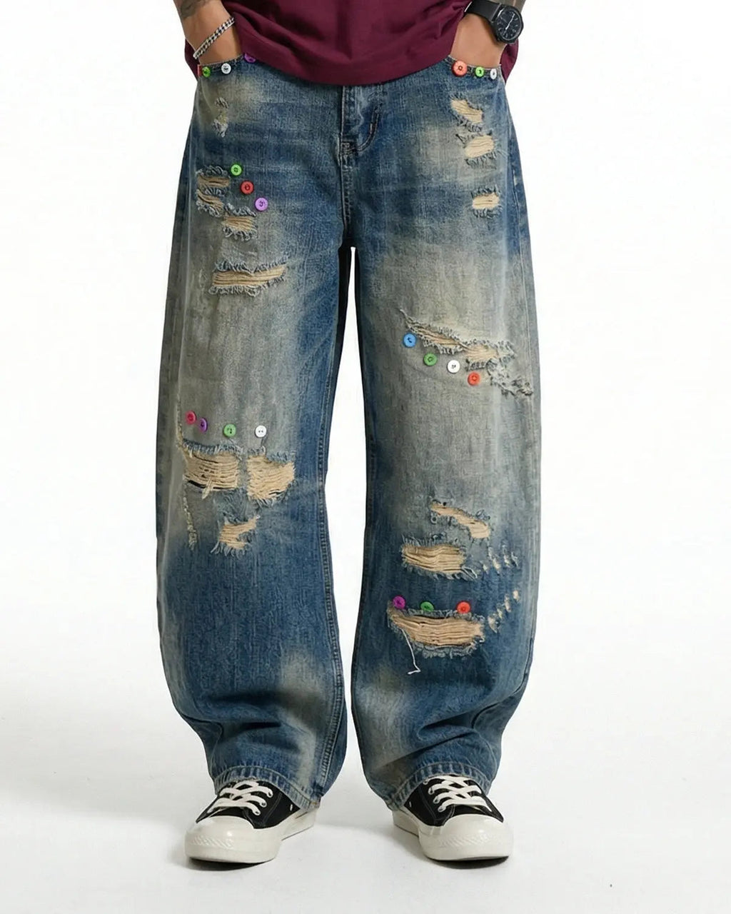 Distressed button barrel jeans by INFLATION, stylish streetwear pants with a worn, rugged look and metal button details.