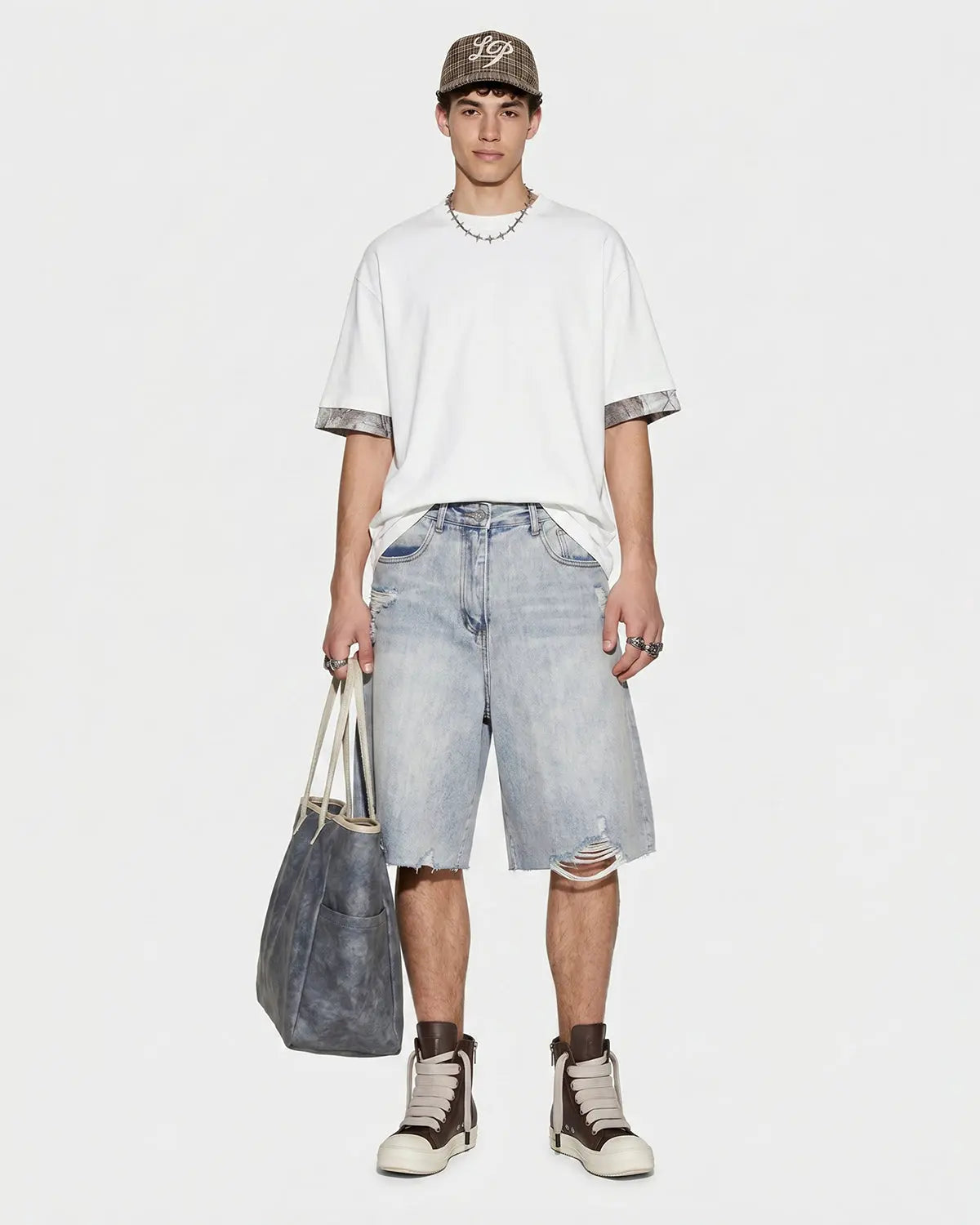 Inflation brand adjustable waist baggy jorts, casual denim pants with a relaxed fit and distressed details, styled for streetwear.