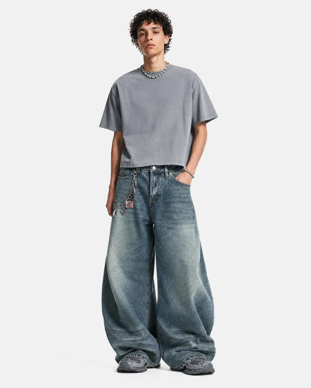 Inflation Whisker Acid Washed Barrel Jeans showing distressed denim texture and relaxed fit in a casual streetwear style.