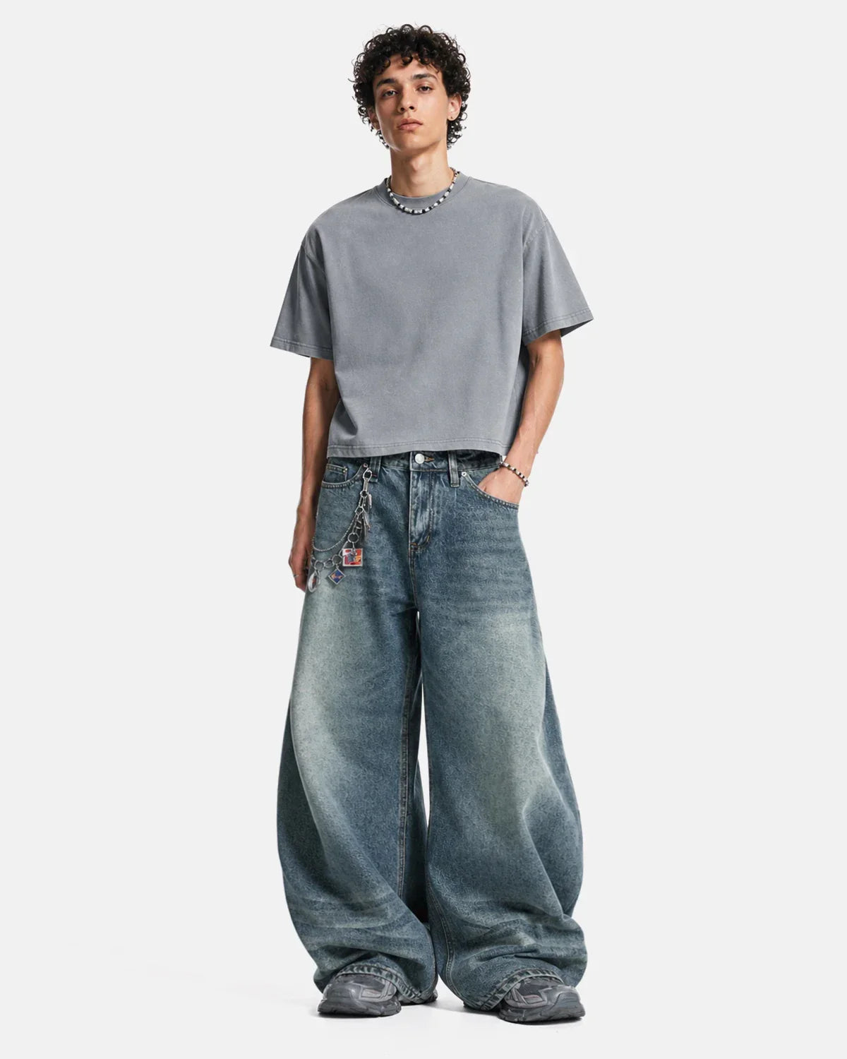 Inflation Whisker Acid Washed Barrel Jeans showing distressed denim texture and relaxed fit in a casual streetwear style.