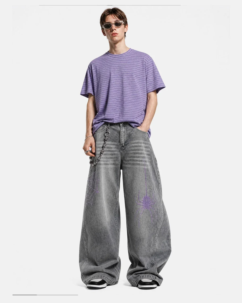 Flation streetwear spider graphic rhinestone barrel jeans showing detailed spider design and sparkling rhinestones on the denim pants.