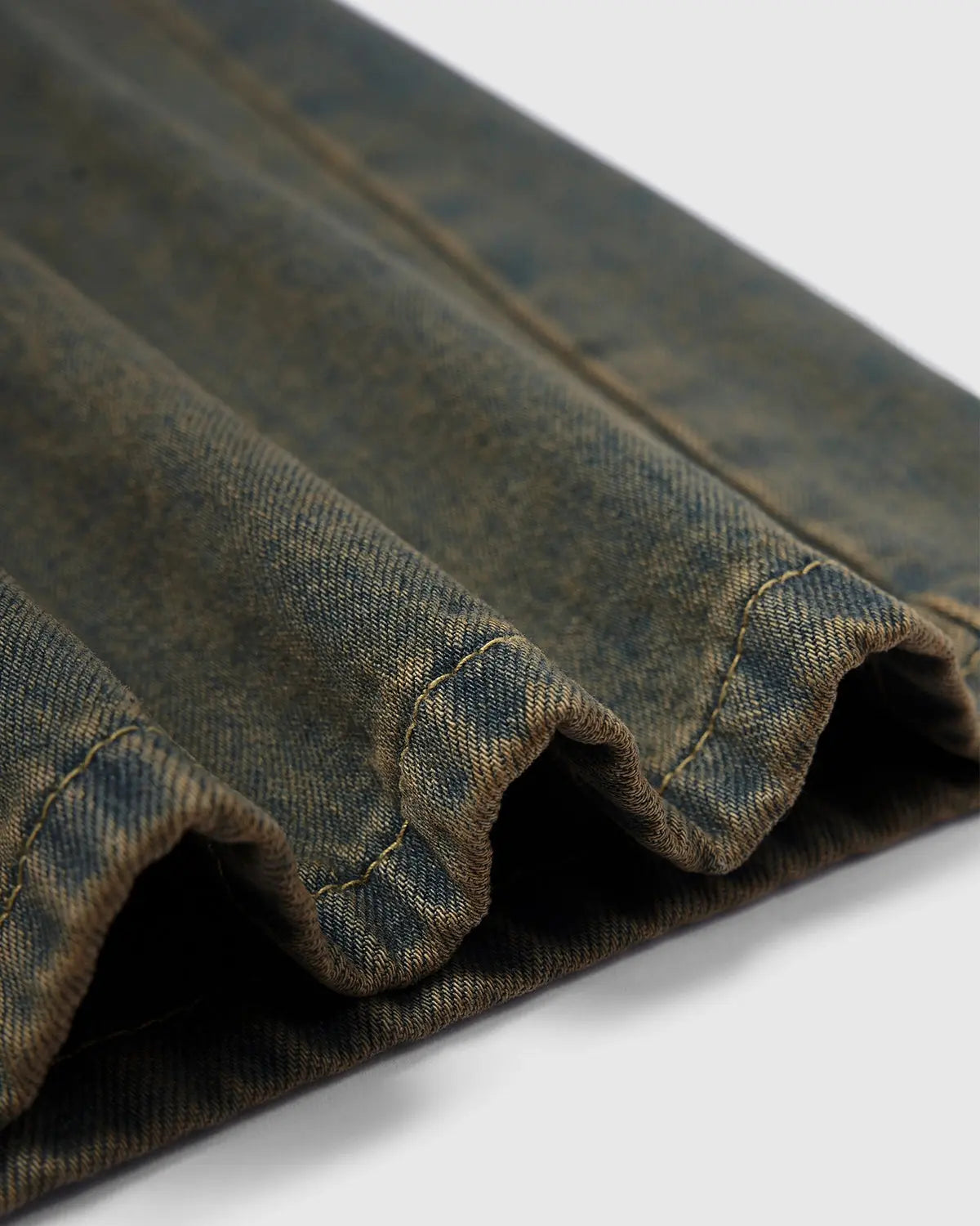 Flation Streetwear washed loose-fit denim pants with distressed details and relaxed fit, displayed on a hanger.