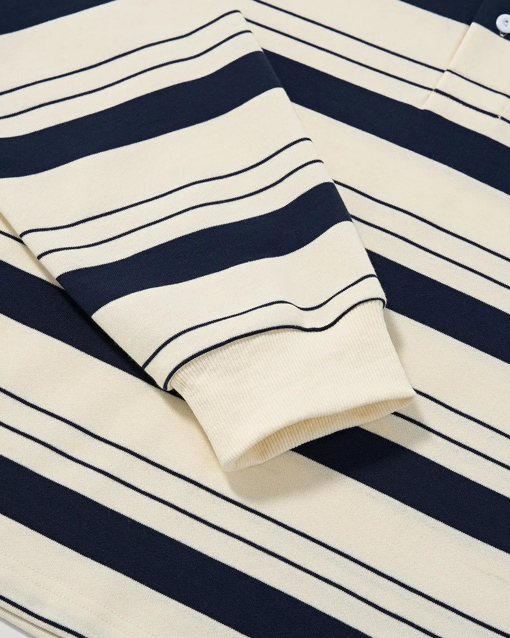 Flation striped rugby polo shirt featuring a classic collar, short sleeves, and bold horizontal red and navy blue stripes.