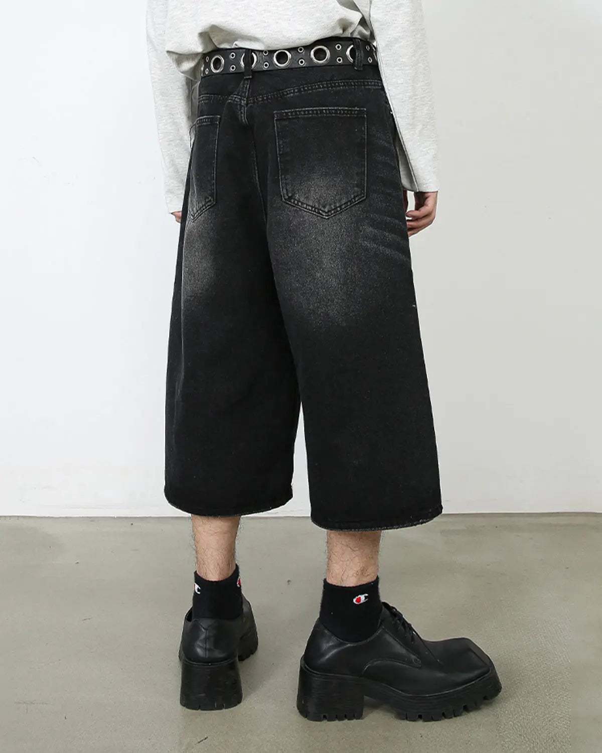 Washed baggy denim jorts by INFLATION featuring a relaxed fit, distressed details, and casual streetwear style.